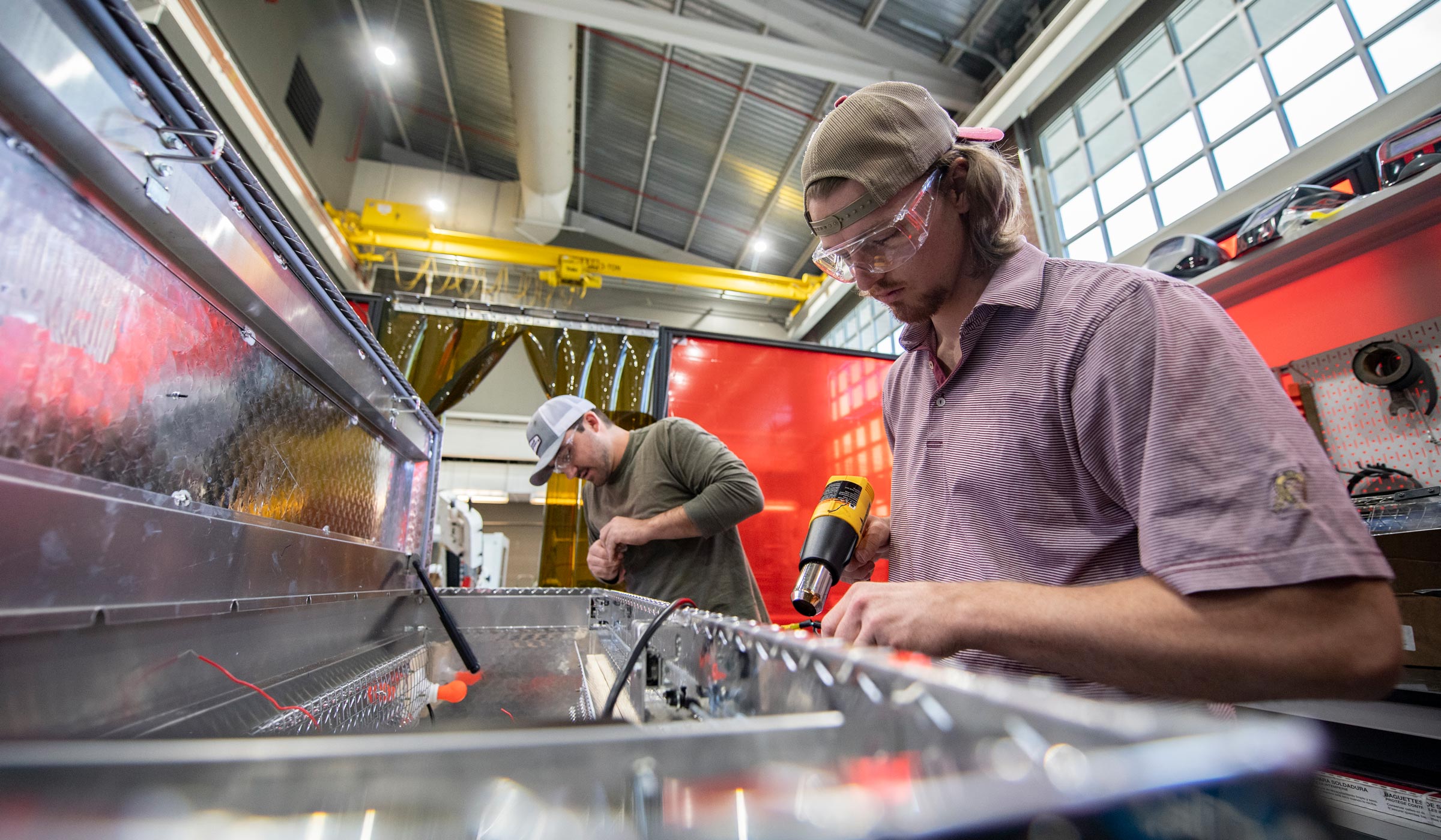 Two mechanical engineering students, Ryden Smith, right, of Tuscaloosa, and Wesley Cameron of Richton, work to convert a truck toolbox into a UV sterilization device at Mississippi State’s Center for Advanced Vehicular Systems. The device will be used to sterilize masks for MSU&#039;s Longest Student Health Center Staff, filling a need during the COVID-19 pandemic and a national shortage of masks.