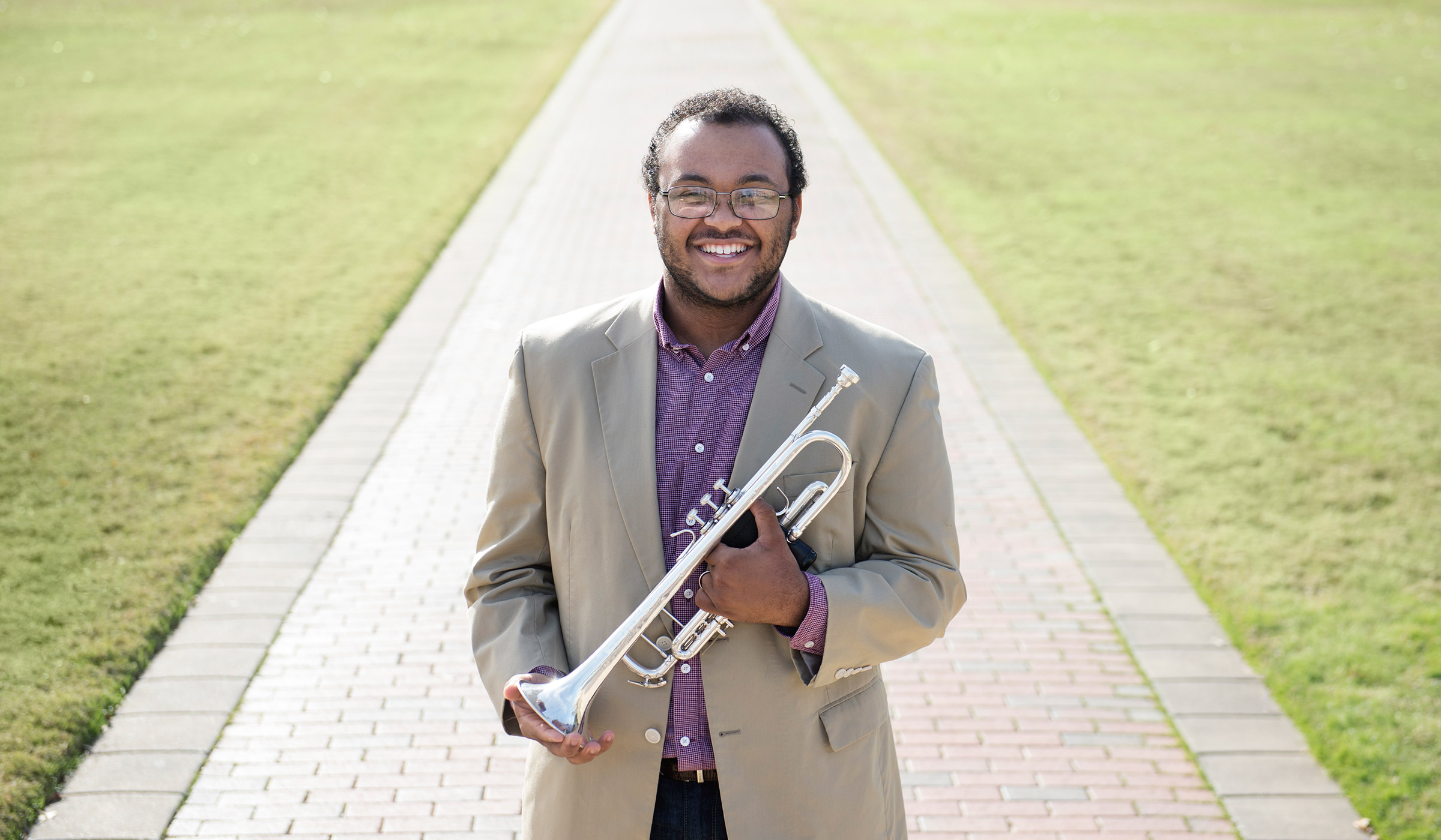 Quin Gray, pictured holding a trumpet on the Drill Field.
