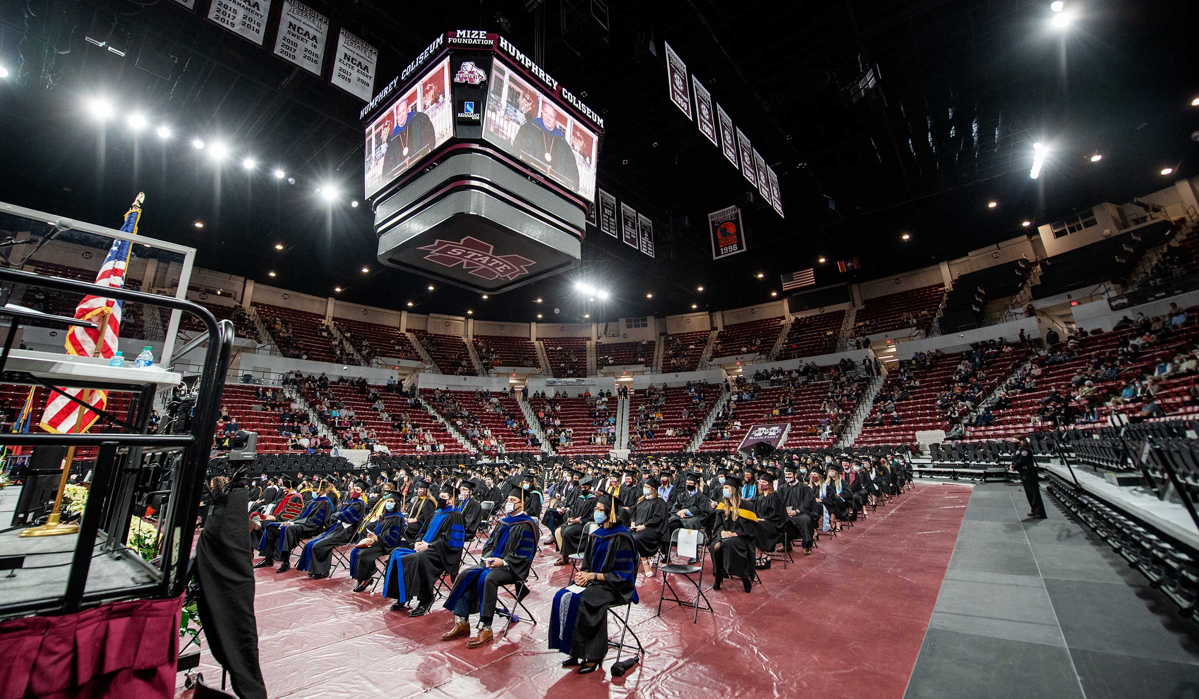 President Keenum addresses socially distanced graduates from the screens at the Hump.