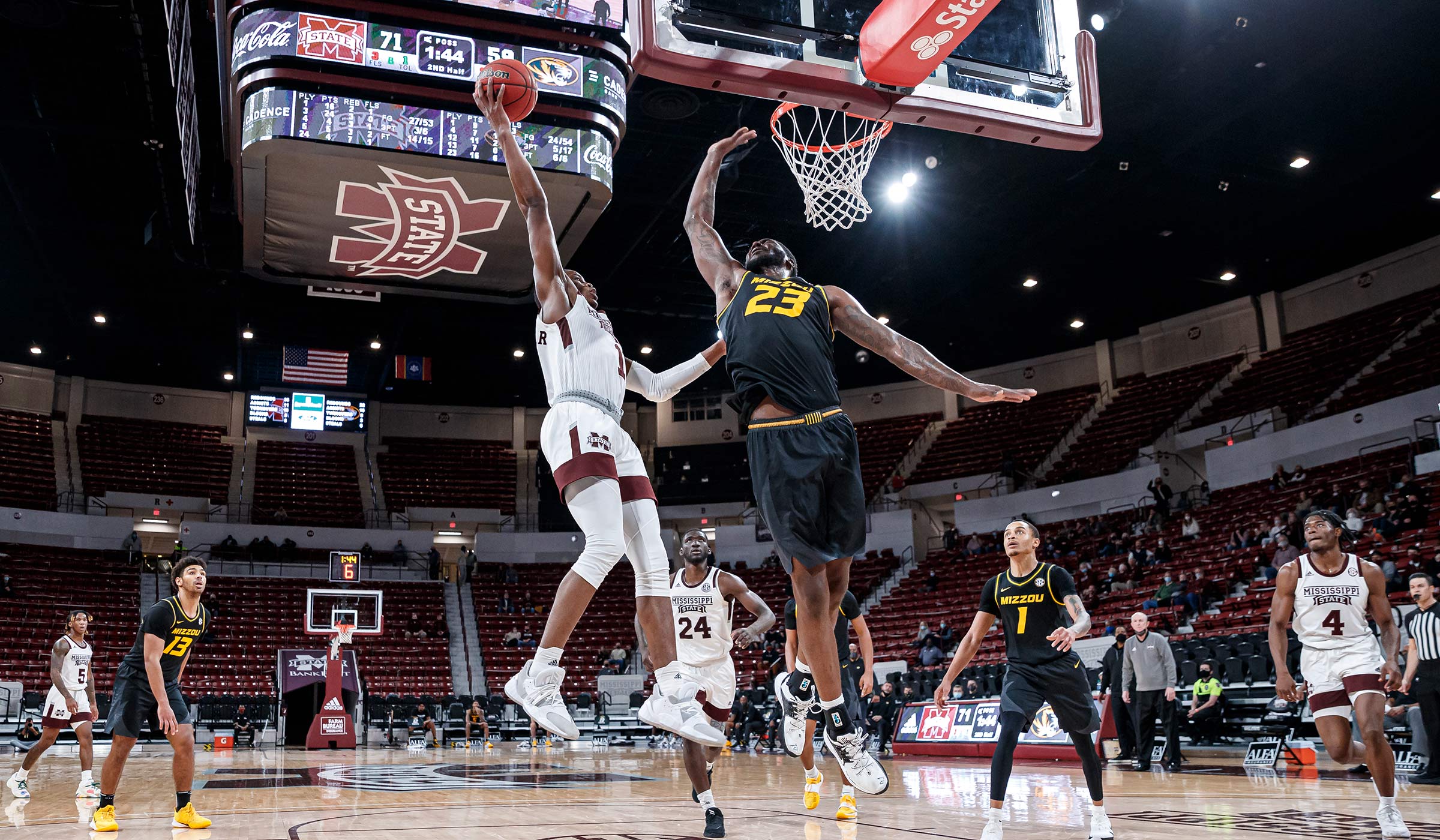 Men&#039;s Basketball player Molinar leaps to the basket over Missouri, winning in a mostly empty Hump. 