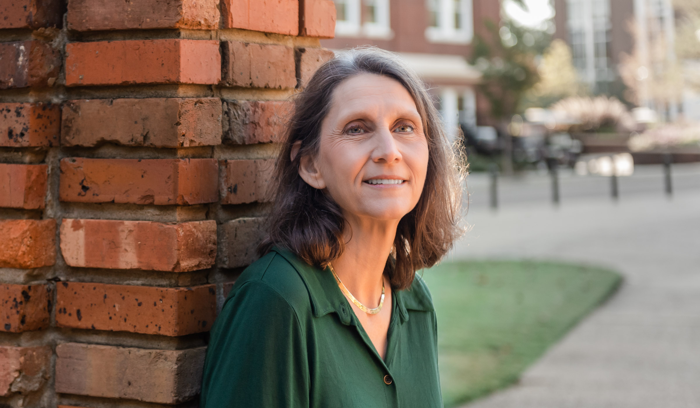 Kim Walters, pictured standing next to a brick column on the MSU campus.