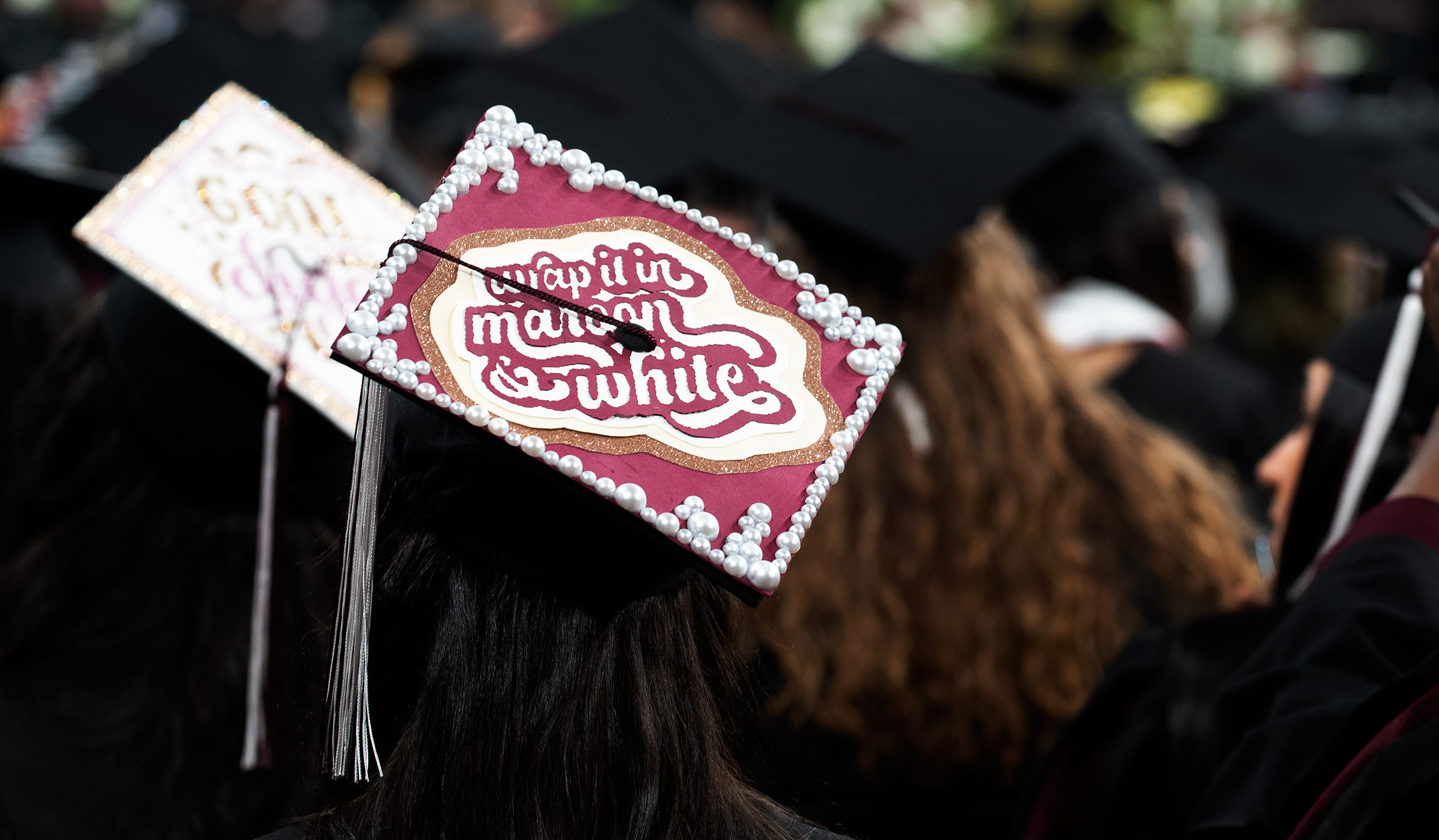 Graduate&#039;s mortar board with &quot;Wrap it in Maroon &amp; White&quot; on top