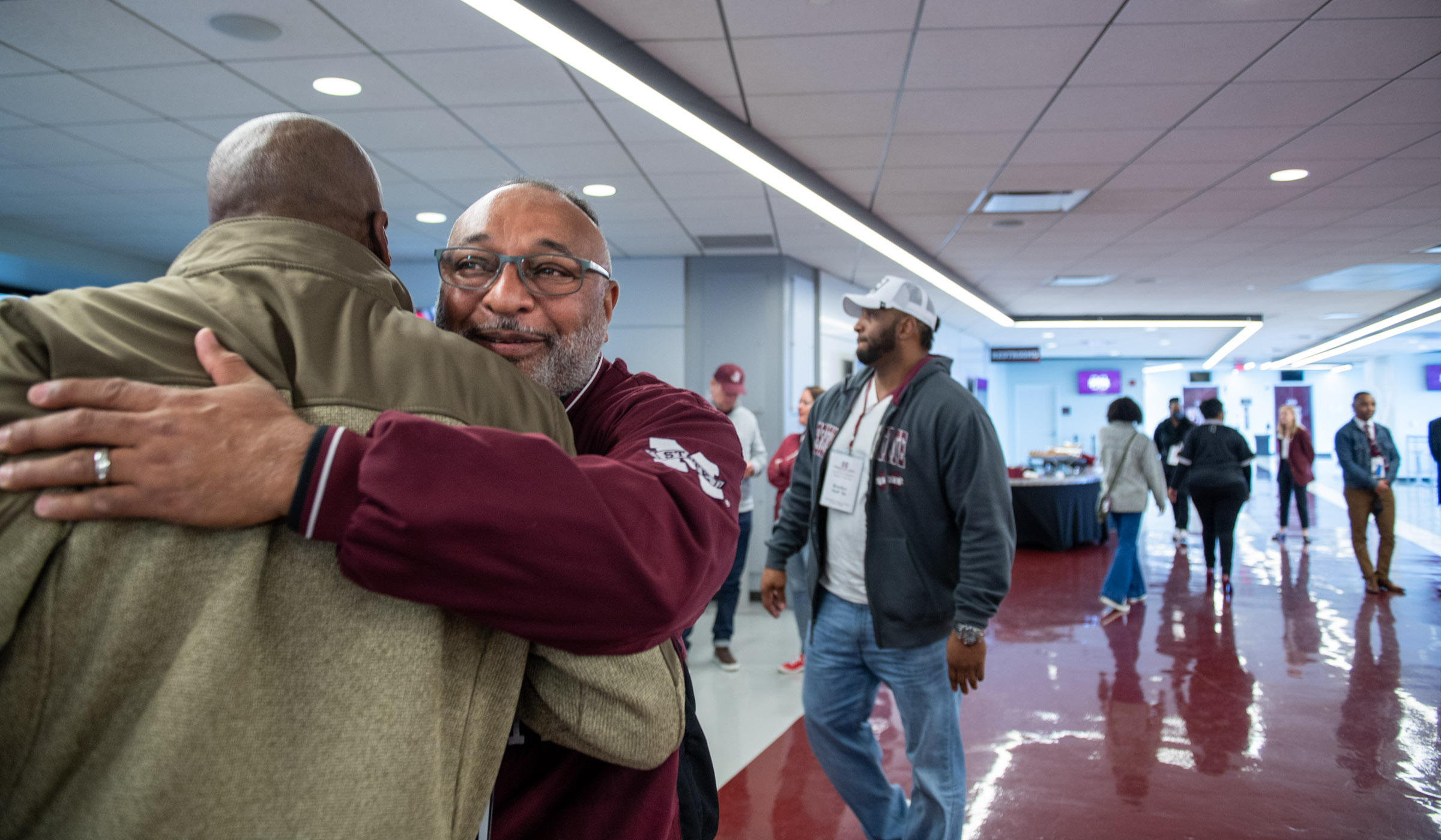 Alumni greet eachother with hugs at the Black Alumni Weekend Athletics Luncheon