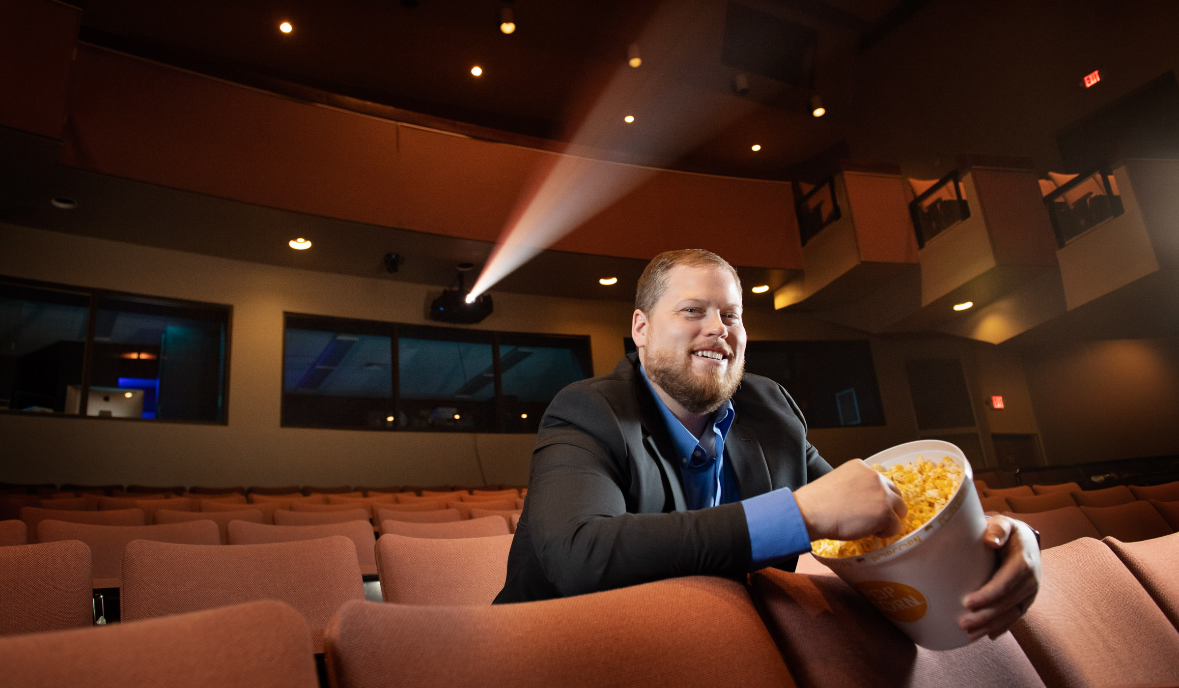 Chris Misun, pictured sitting the McComas Hall Theatre