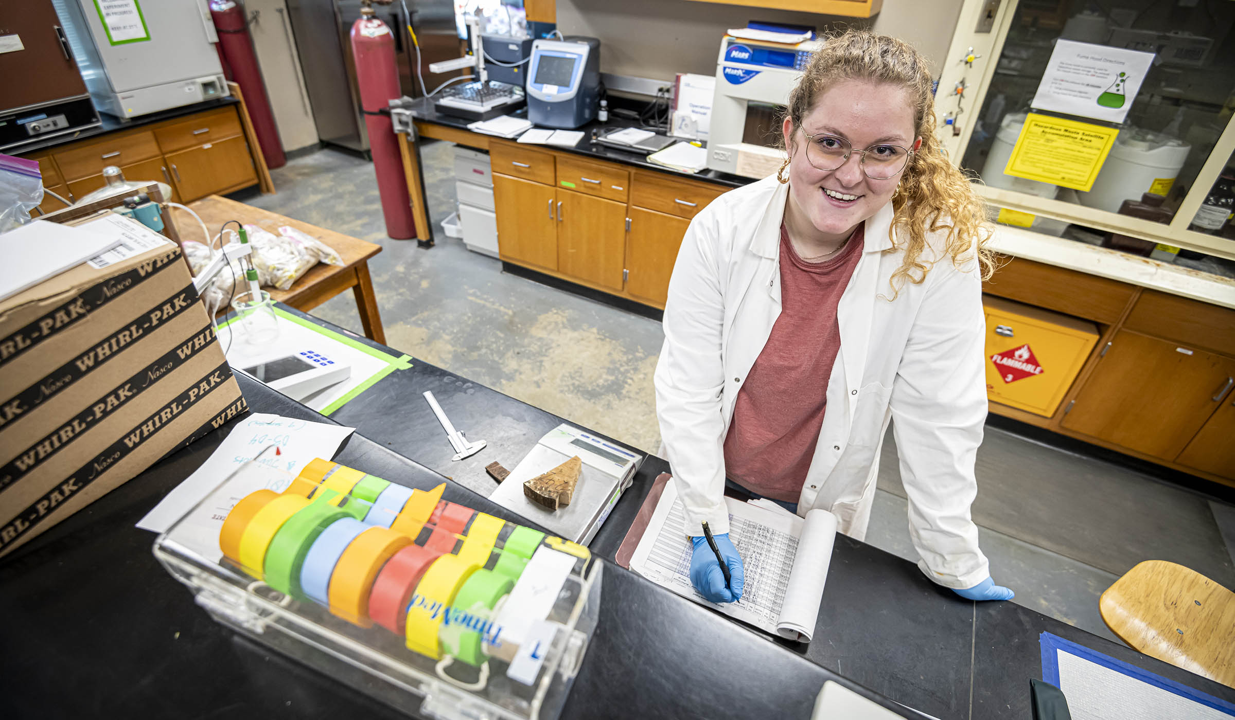 Emily White, pictured taking notes in a lab setting.