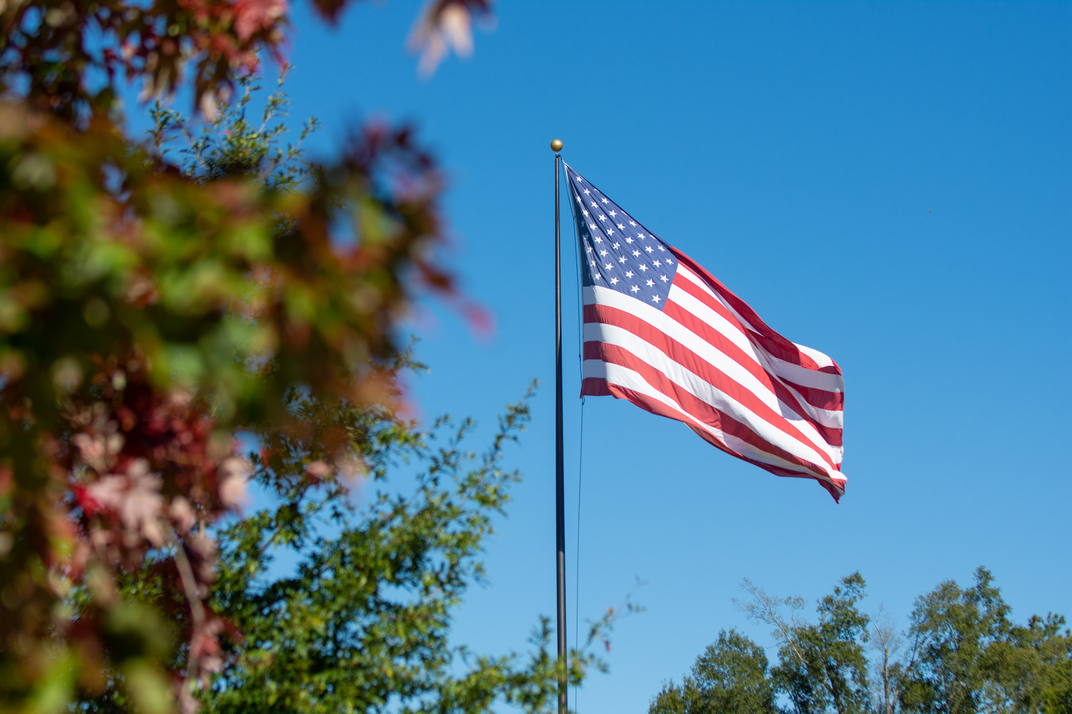 The American Flag waves over the Drill Field.