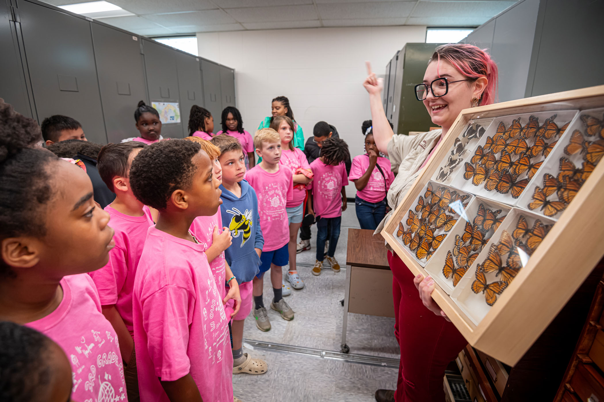 MSU’s Shelby Grice, a Mississippi Agricultural and Forestry Experiment Station lab technician, shows middle schoolers a display with white admiral and viceroy butterflies during last week’s Bug and Plant Camp. The summer, week-long experience introduces young students to insect collection and preservation, while also familiarizing them with habitats. The annual camp is sponsored by MSU’s Department of Biochemistry, Molecular Biology, Entomology and Plant Pathology.    