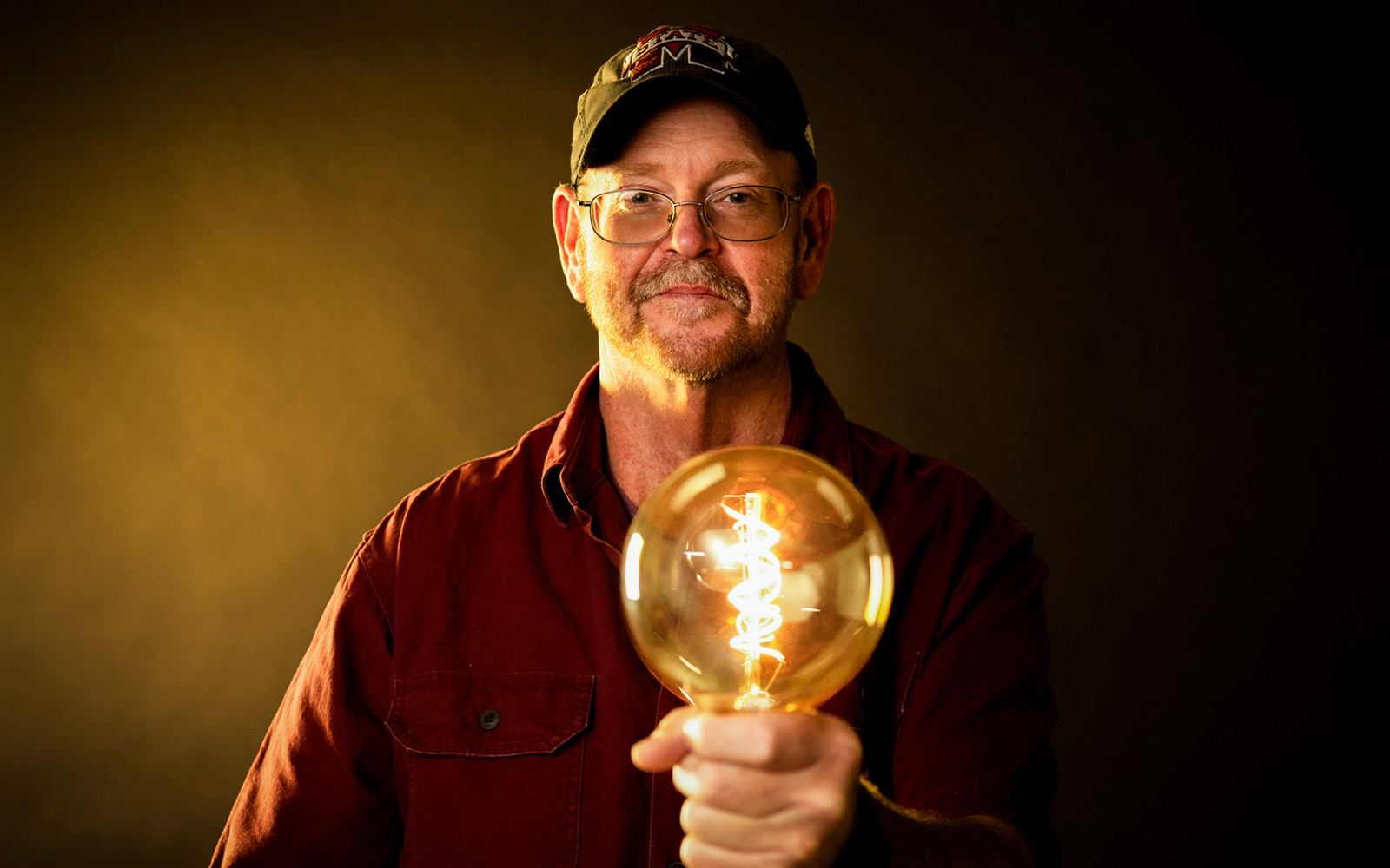 Anthony “Bubba” Forrester holding a lightbulb