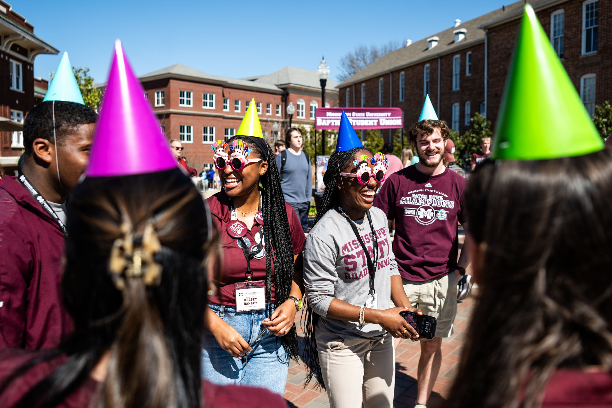 MSU Roadrunners Kelsey Danley and Keaura Mearday go the extra mile in festive style for MSU's 147th birthday party on YMCA Plaza.