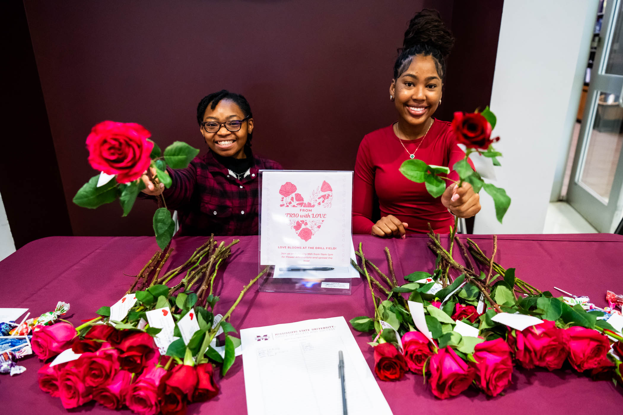 TRiO students Aisha Williams, a junior management major (left) and senior Bio Sciences major, Kasia Williams (right,) spread kindness by handing out roses, each accompanied by a note of positive affirmations to kick off the week of Valentine's Day.