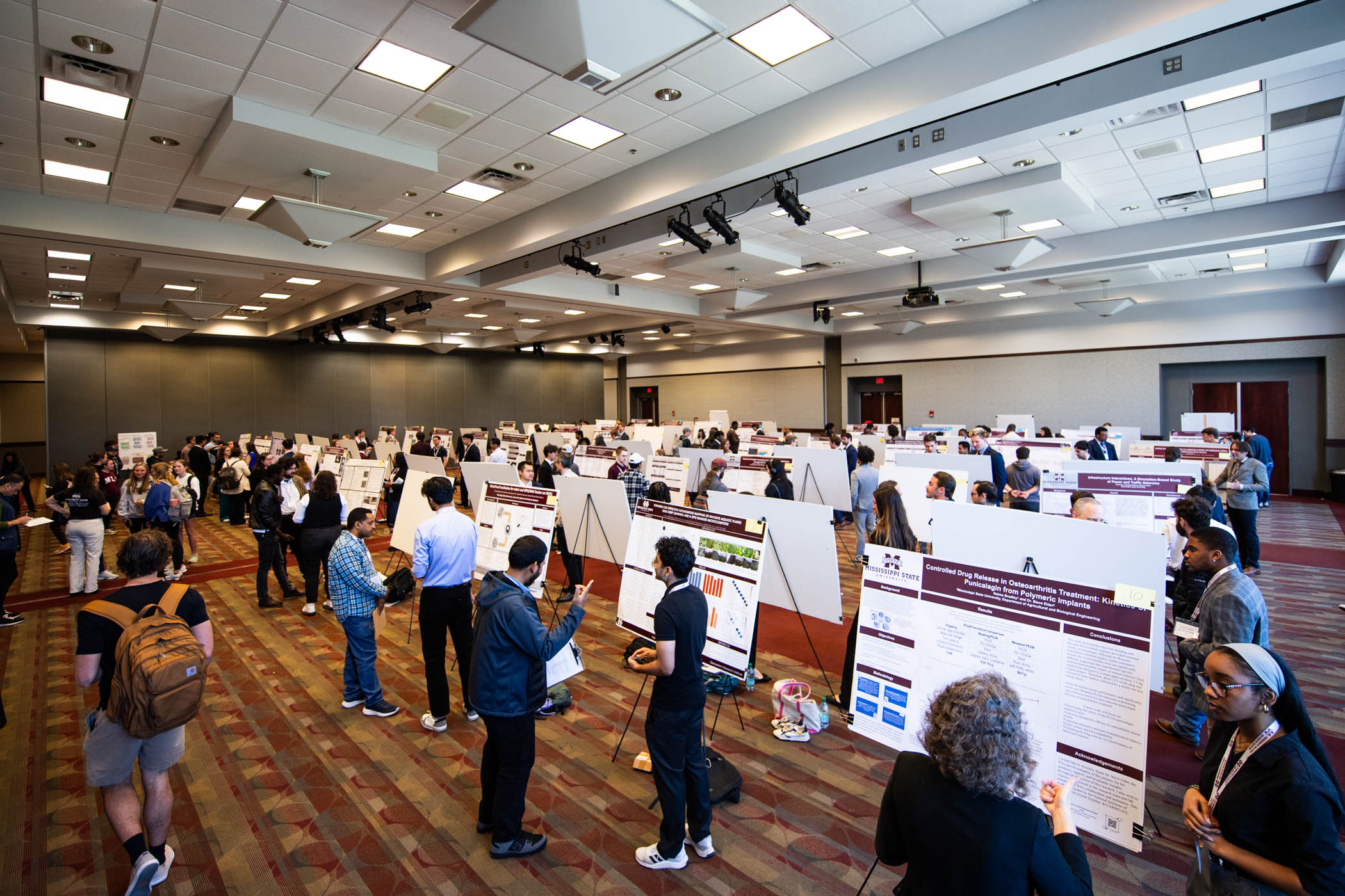 Poster presentations fill the entirety of Colvard Student Union's ballroom for MSU's annual Undergraduate Research Symposium. Presented by MSU's Bob and Judy Shackouls Honors College and the Office of Undergraduate Research and Creative Discovery, the event spotlights student-led discoveries in science, engineering, humanities, and the arts. With presentations, special competitions, and campus-wide collaboration, students are able to not only showcase their knowledge but also their dedication to their respe