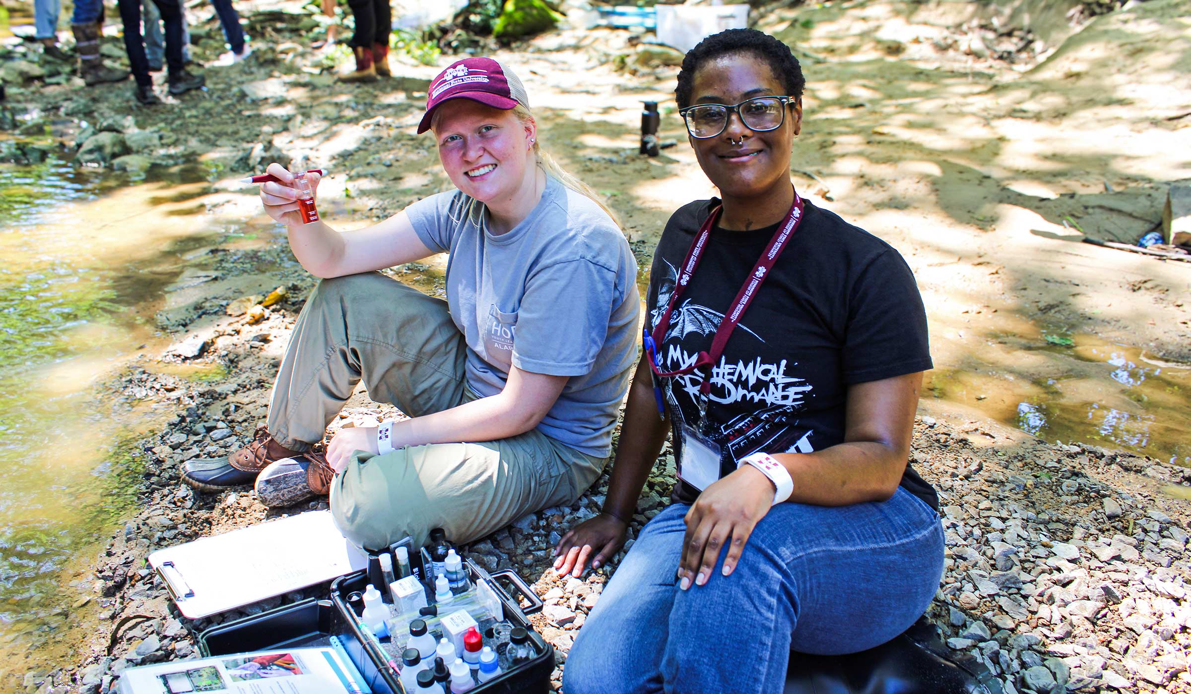 Incoming freshmen sample creek water during Acorn Academy's environmental stewardship course.