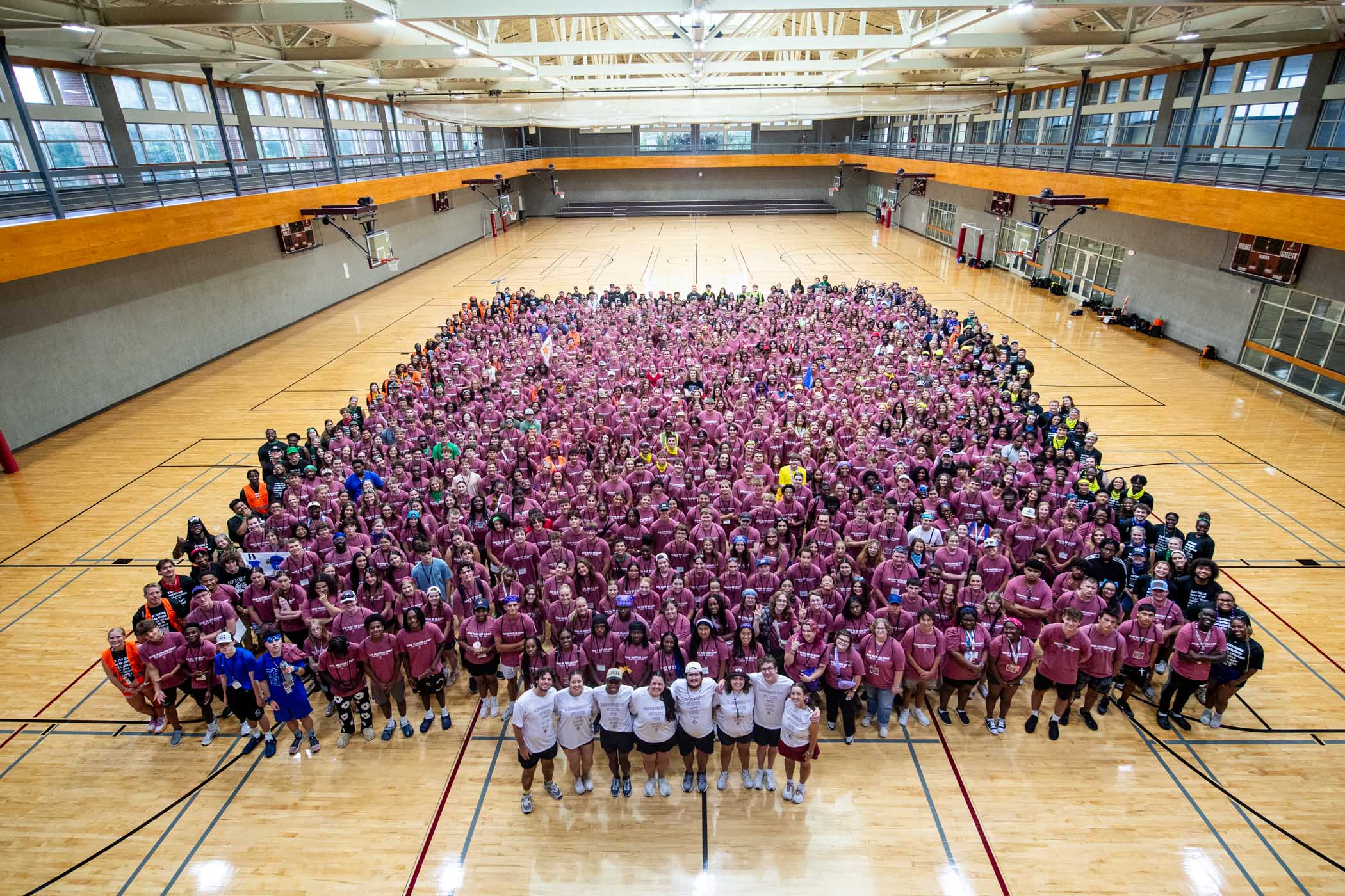 New Maroon Campers, counselors, and executive team members gather in the Sanderson Center’s main gym for an annual group photo, celebrating a new class of Bulldogs eager to kick off their journey at MSU. 