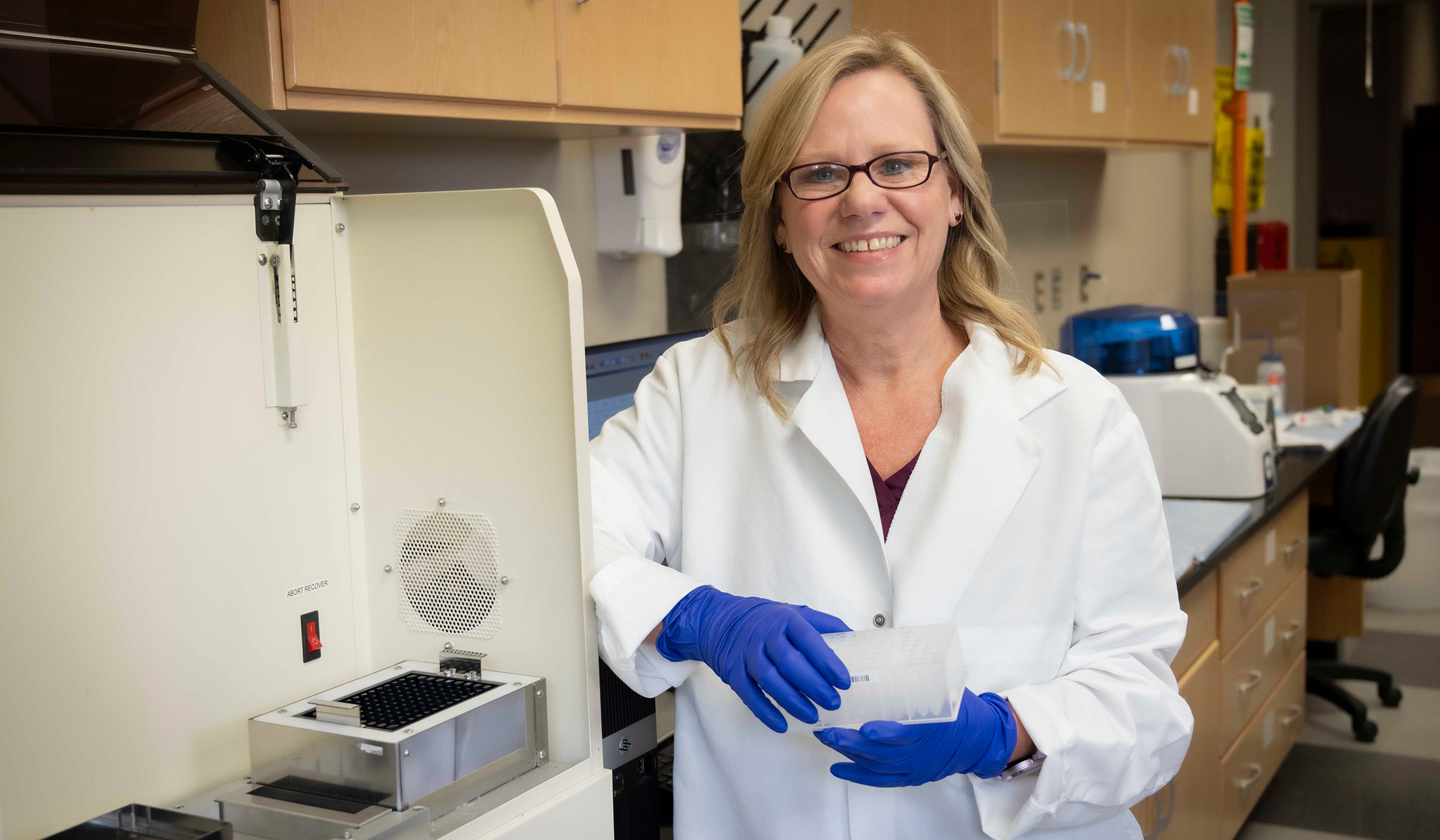 a woman standing in lab