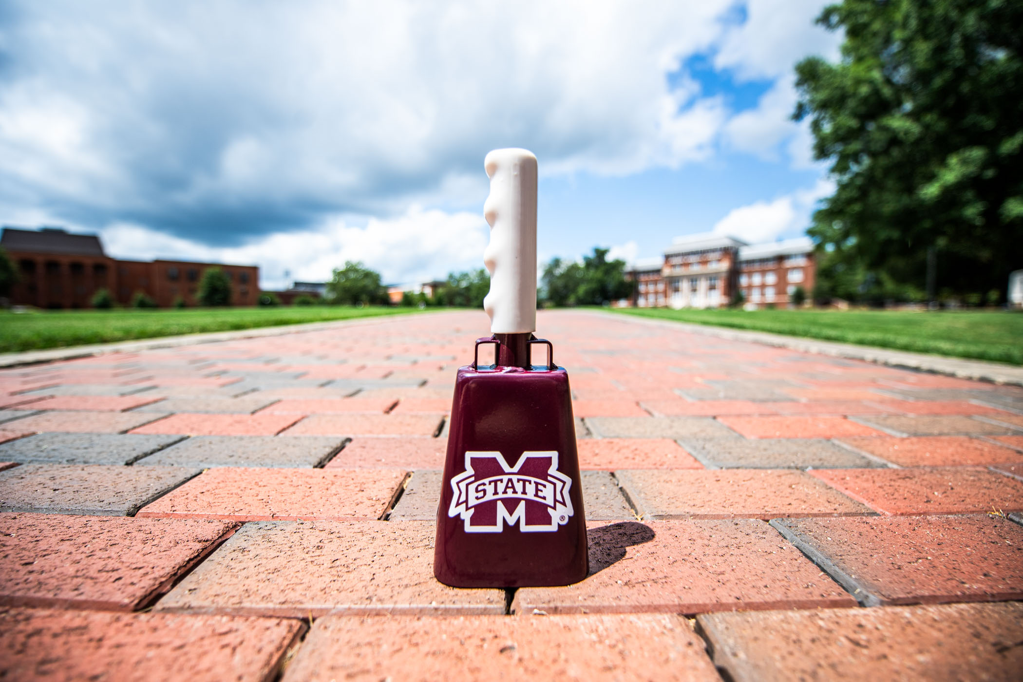A cowbell, MSU's longstanding symbol of pride, rests in the center of a sunbathed Drill Field pathway Thursday afternoon [August 5.] 