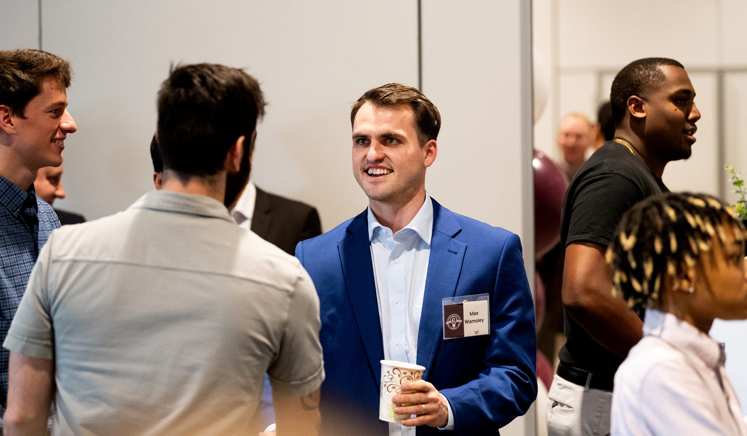 man in blue suit smiling