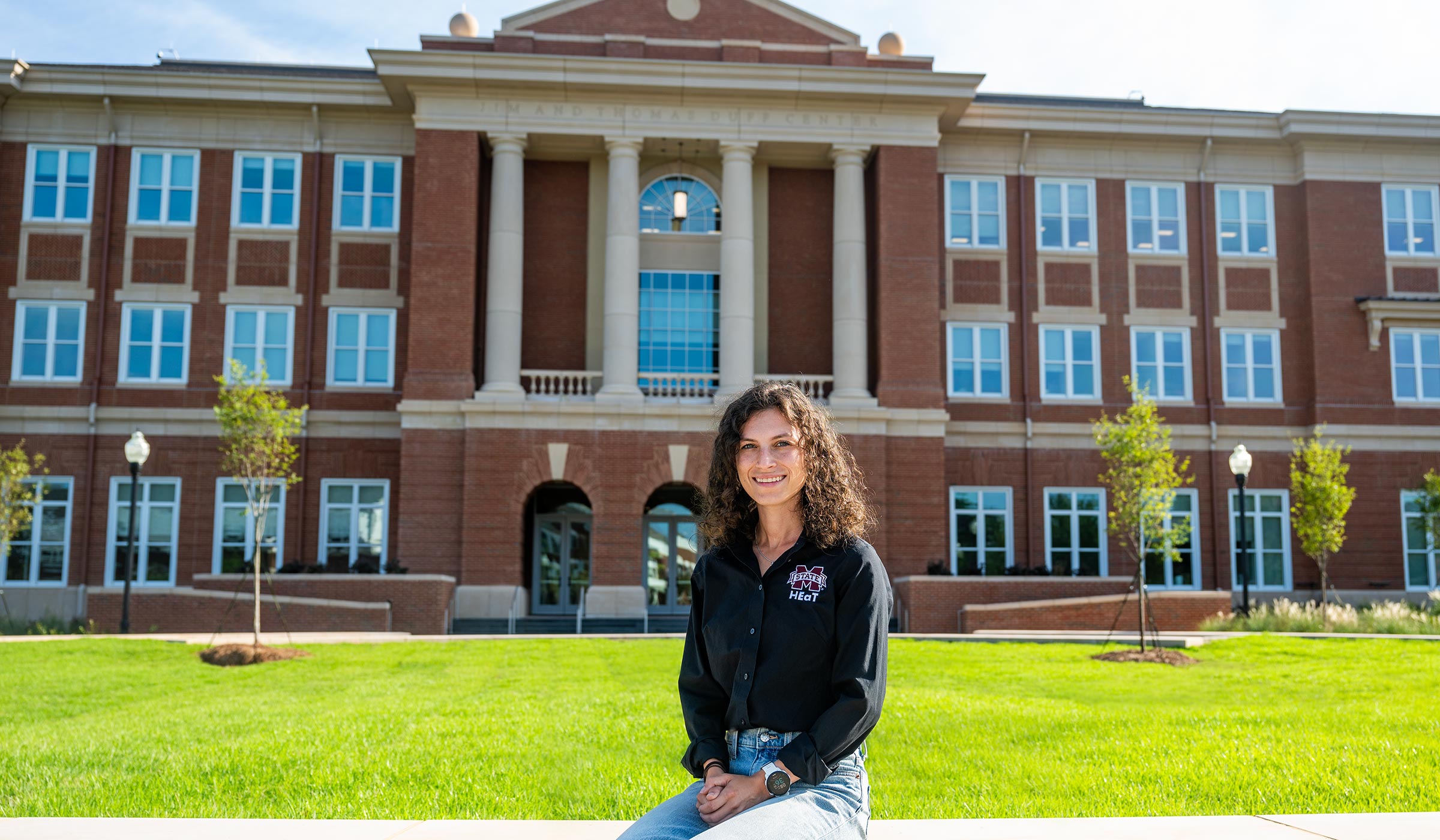 young woman in front of building