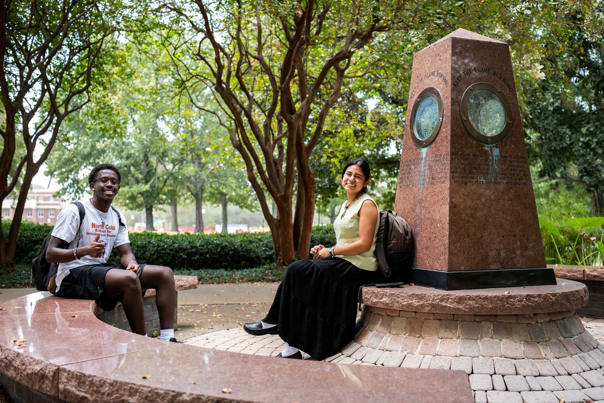 From left, junior biochemistry major Armani Karomo of Acworth, Georgia, and sophomore marketing major Leila Alvarado of Olive Branch enjoy each other’s company while sitting by the Eternal Flame Monday [Sept. 15] in front of Allen Hall. As fall approaches, Starkville’s warm, sunny days and cooler evenings promise comfortable conditions for enjoying campus life outdoors.