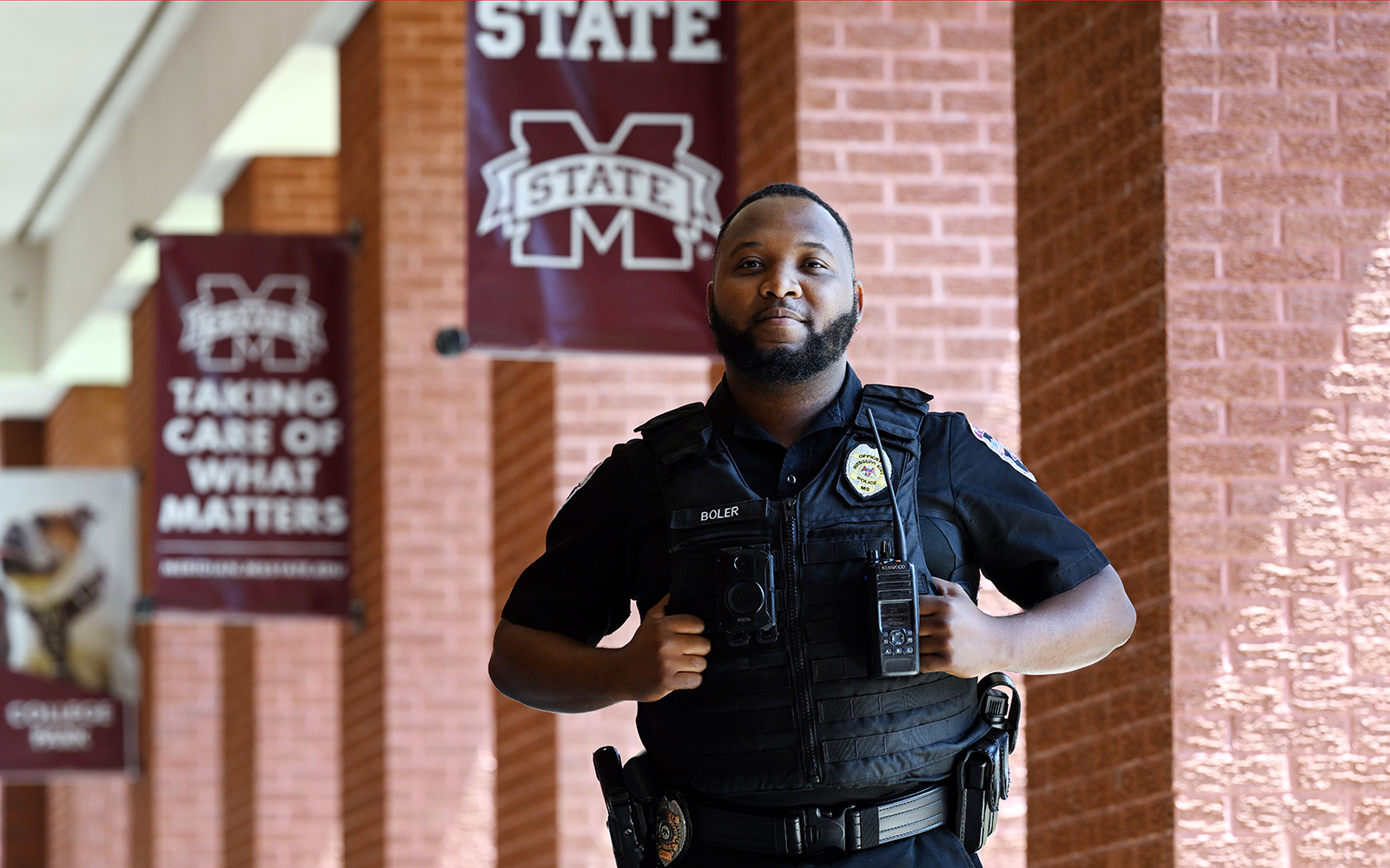 man in police uniform in front of bricks