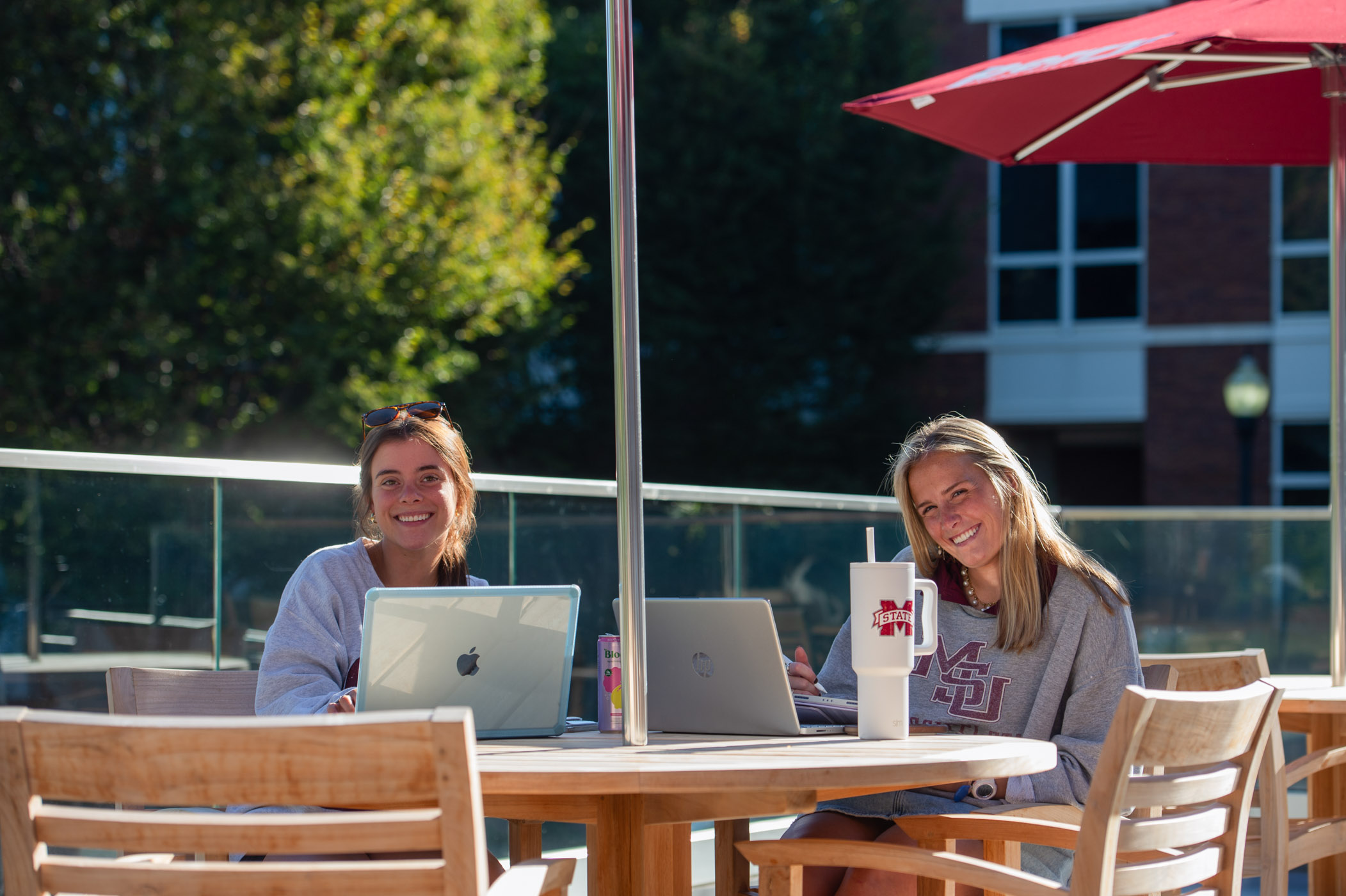Senior kinesiology student Graci Laird (left) and junior educational psychology student Kate Fairburn (right) take their studies outdoors to the newly built upper-level patio at Perry Food Hall — one of the upgraded outdoor and lounge spaces added during the dining hub's recent renovations.