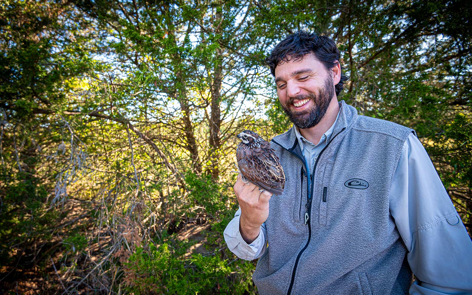 man in woods with bird