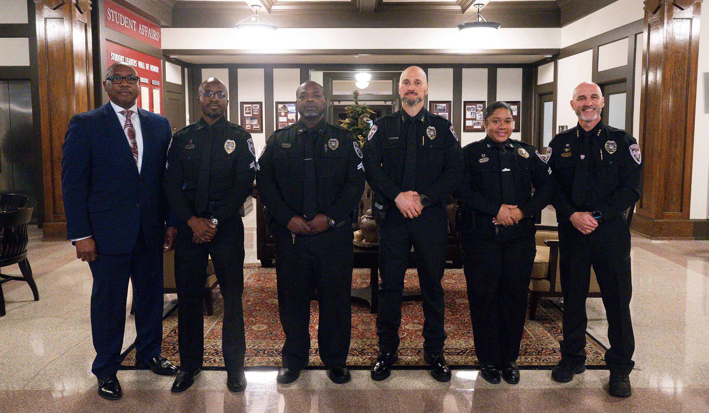Police officers stand in line for a photo as they are promoted to sergeants.