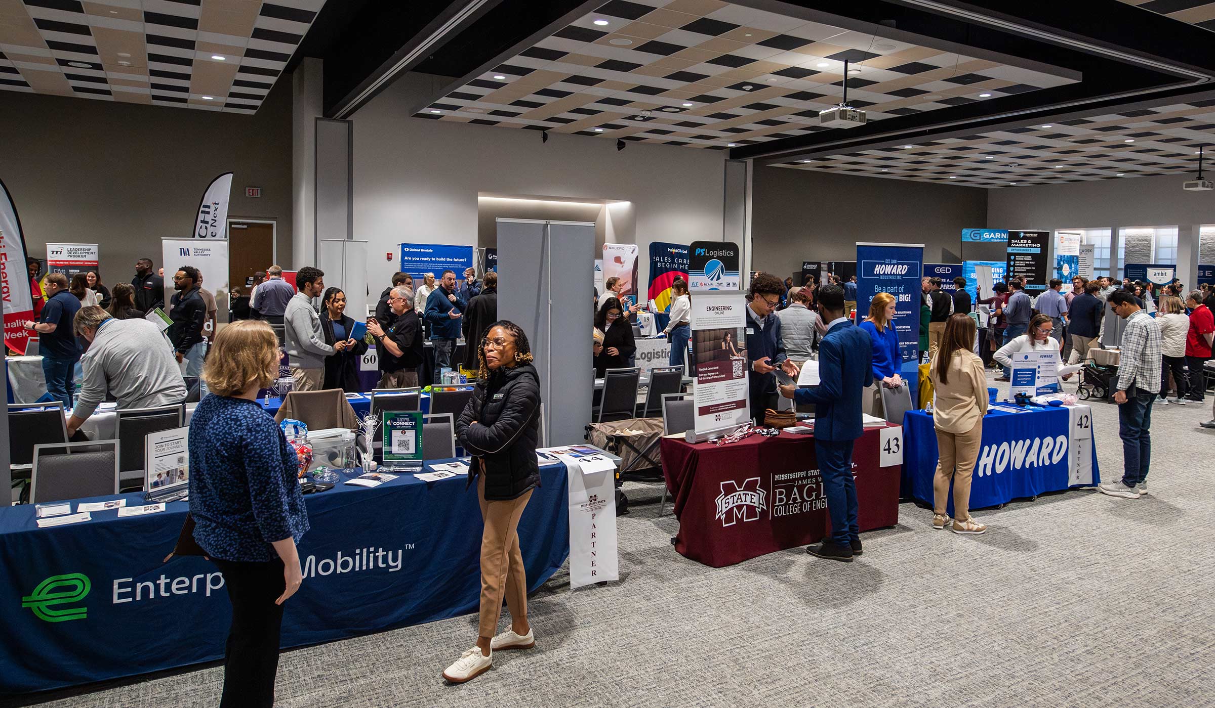 People having discussions at various tables 