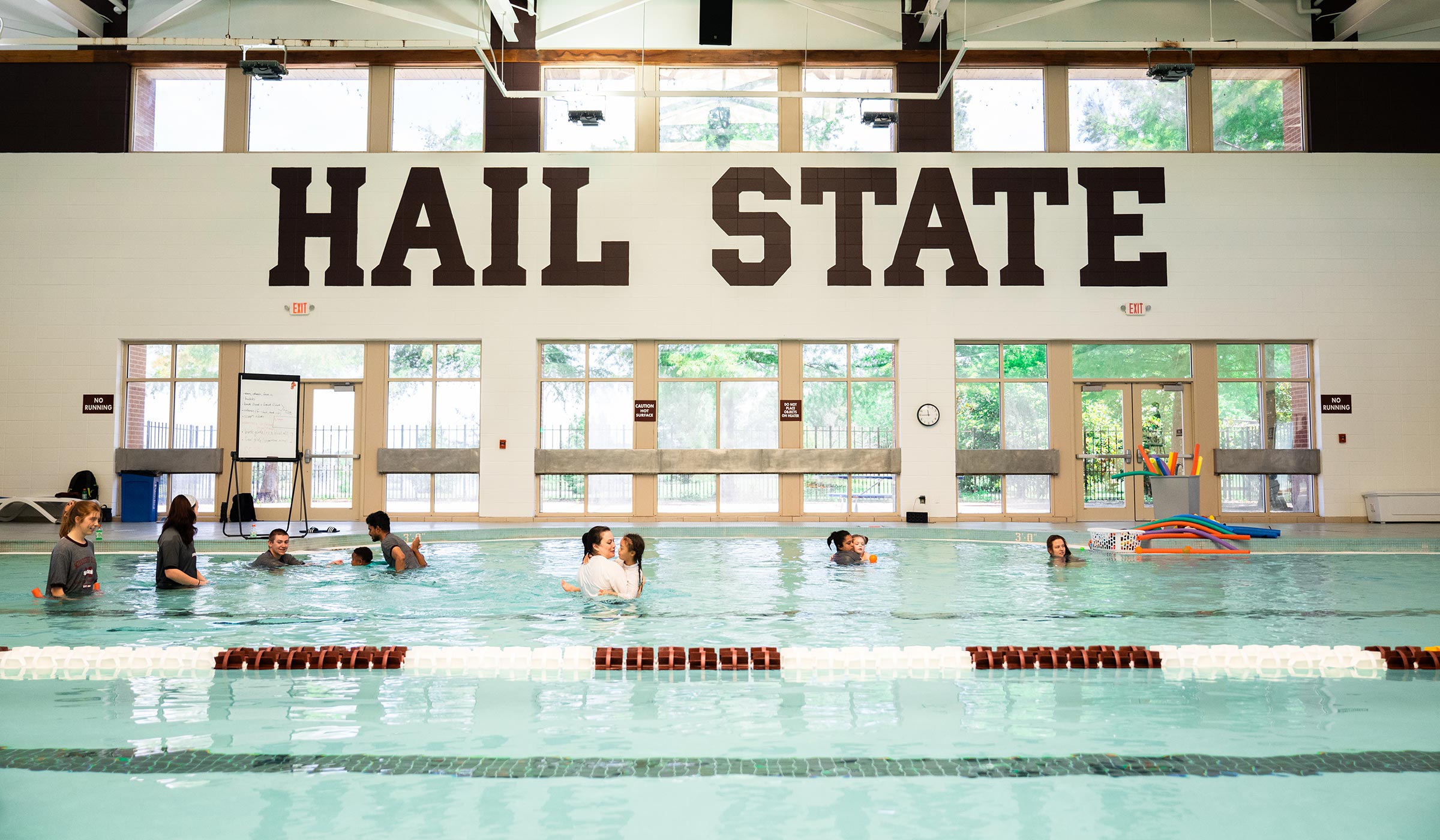 Participants of MSU's Adapted Swim Camp, with the help of instructors, practice their aquatic skills in the pool at the Sanderson Center.