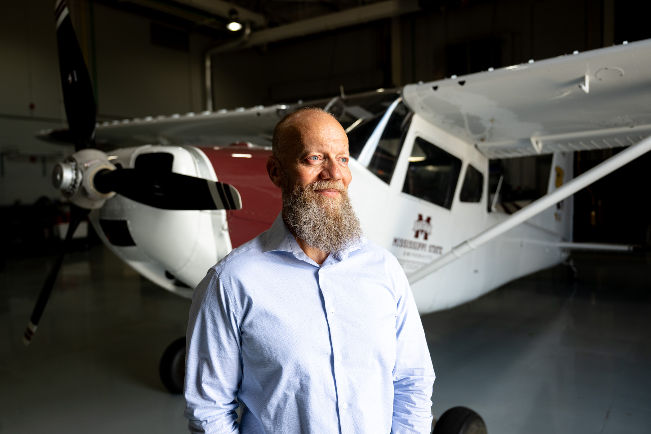 Shawn McNutt standing in front of an airplane