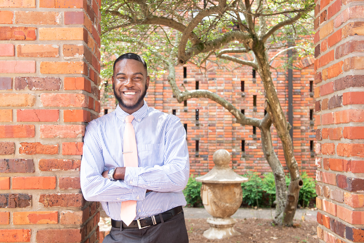 Kendrick Addison in a shirt and tie standing at the Chapel of Memories