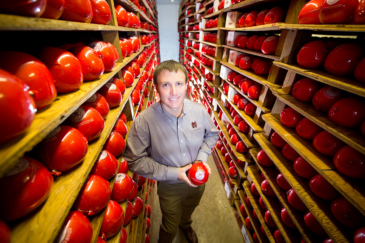 Eric Goan, surrounded by a full stock of MSU Cheese.