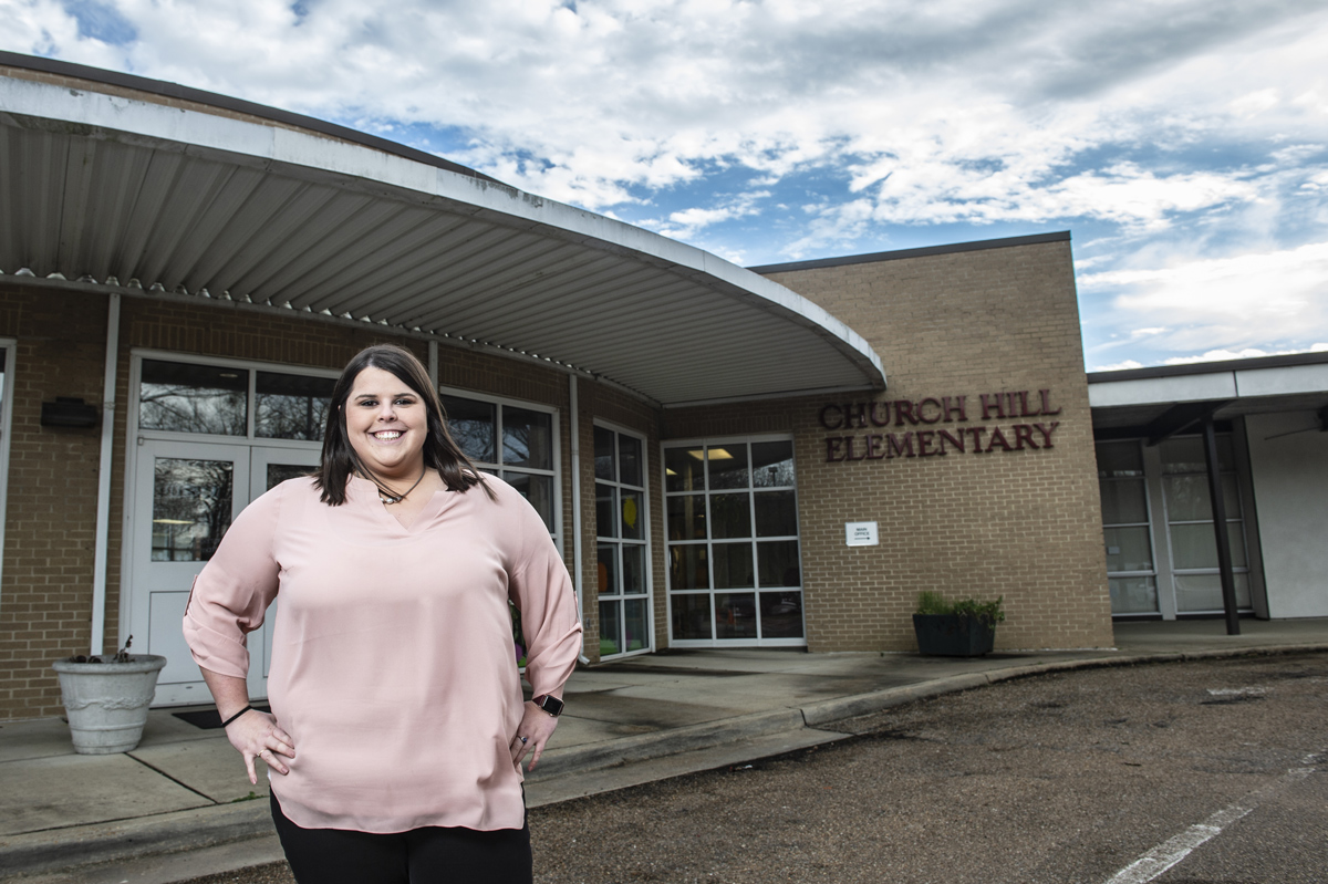 Mary Helon Hays, pictured in front of a school.