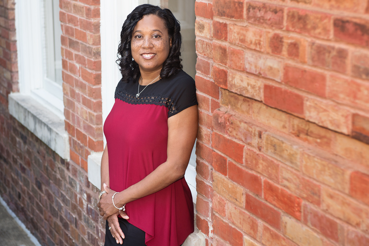 Tawny McCleon, pictured next to a brick building.