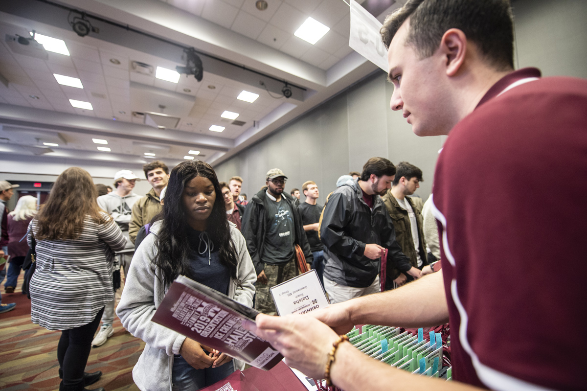 Daisha Roach of Greenwood receives her new student information during the Spring orientation check in the student union.