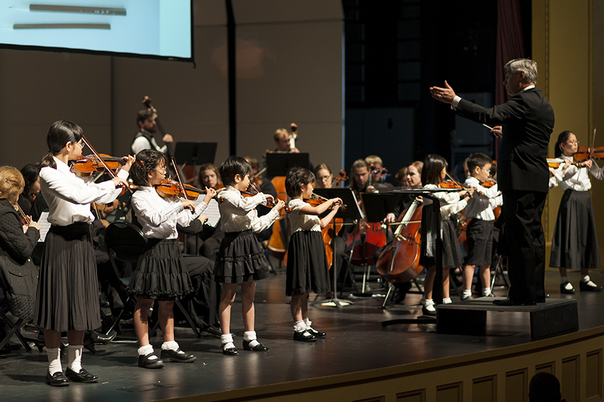 MSU Department of Music Head Barry Kopetz leads eight young violinists and the Starkville-MSU Symphony Orchestra in concert.