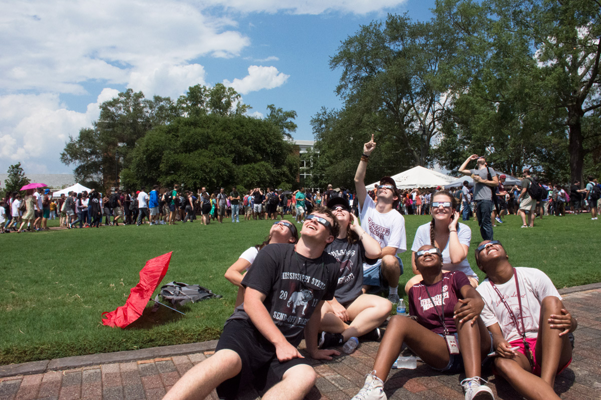 Students watching solar eclipse with proper eye wear on Drill Field