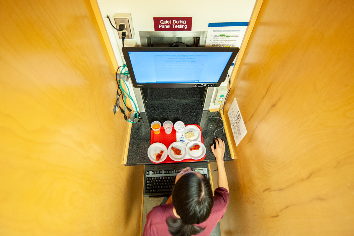 An MSU Graduate Student participates in a Chicken Wing Consumer Tasting Panel.