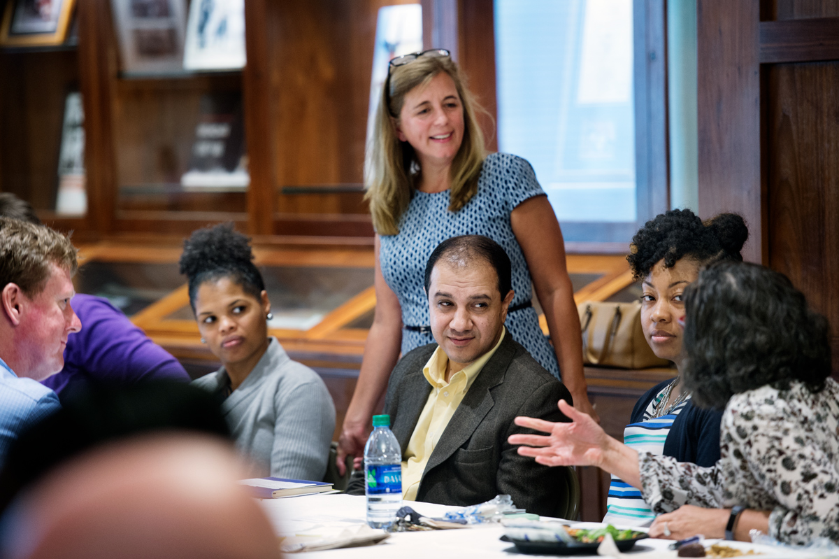 Led by Professor Devon Brenner, a group of Engineering faculty talk over lunch in the Grisham Room