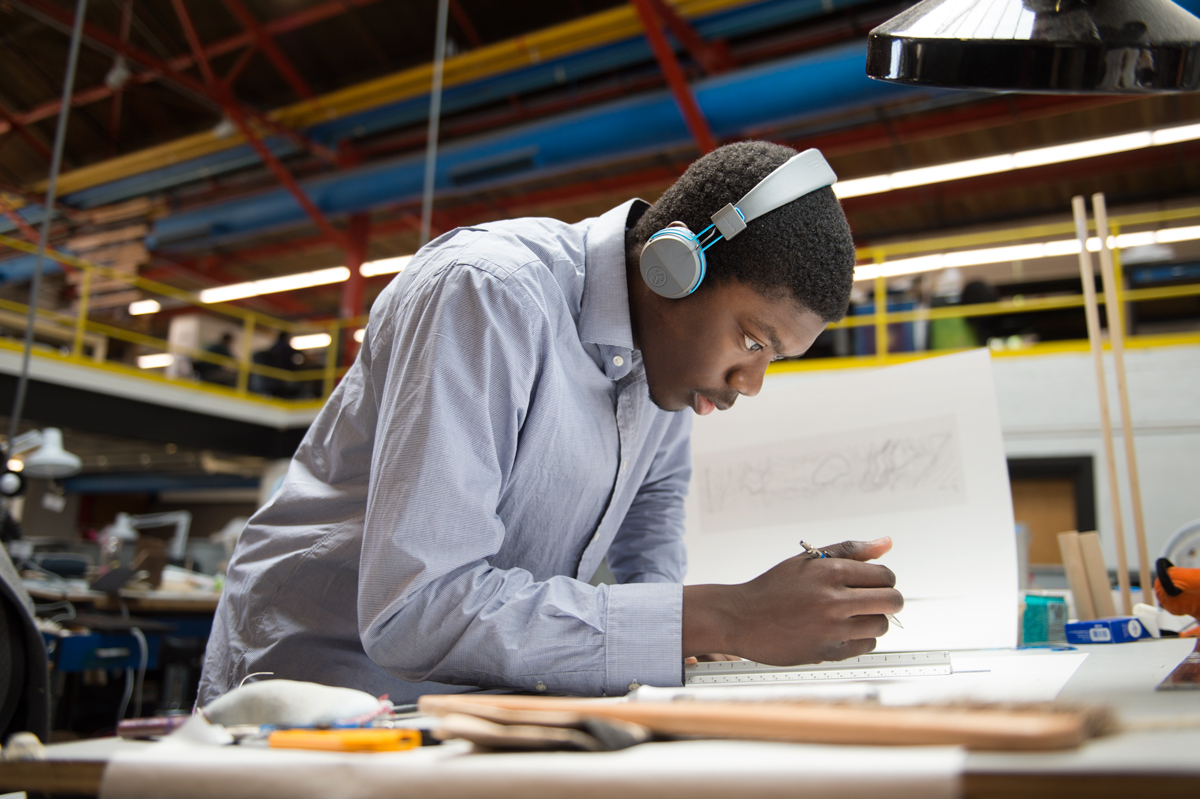 First Year Architecture student De&amp;#039;Vion Dingle draws designs for his last class assignment at his desk in Giles Hall.