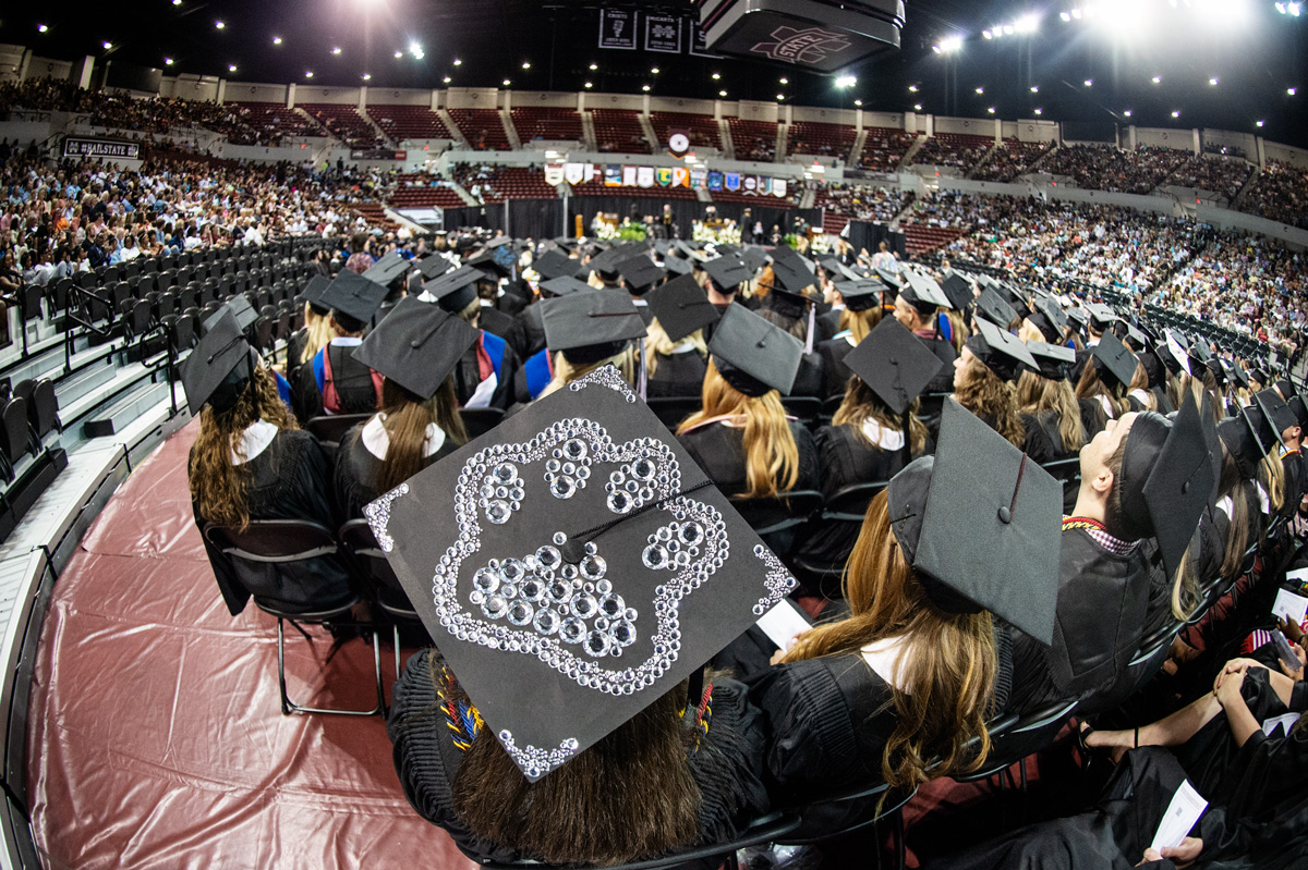 A rhinestone bulldog pawprint decorates the back of a graduate&amp;#039;s mortar board in a sea of fellow graduates in Humprhey Coliseum.