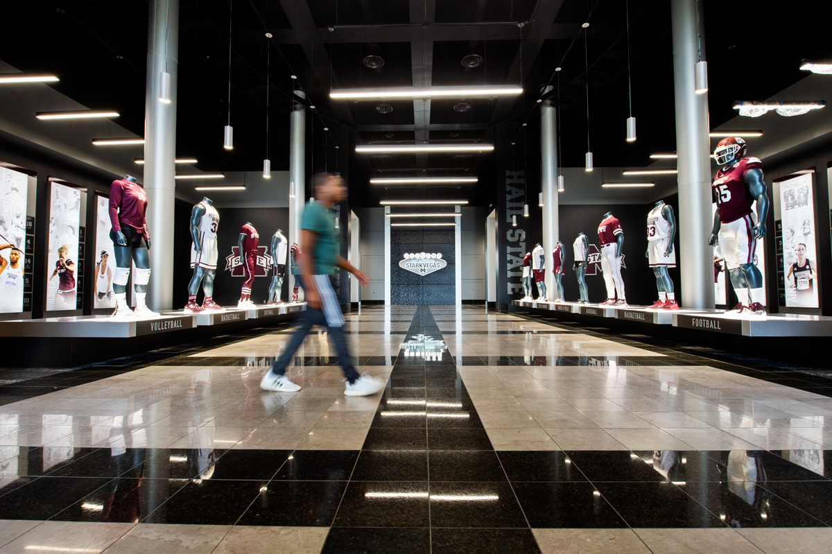 Wide view of remodeled entry space at Templeton Athletic Academic Center, with mannequins wearing team uniforms.