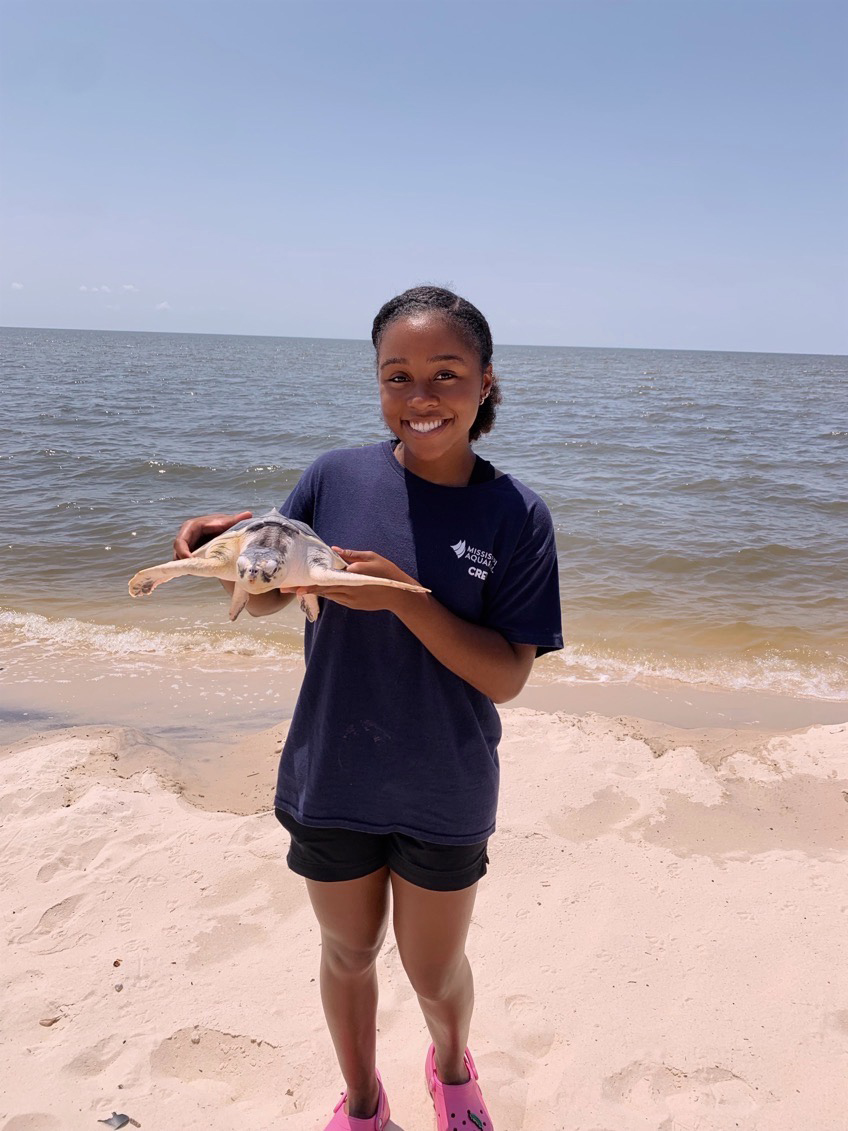 Kristian Jones, pictured holding a sea turtle