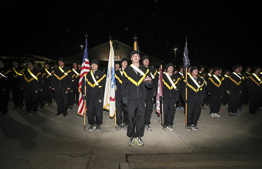 Cadets in Mississippi State’s Army ROTC program deliver the football after completing a previous Egg Bowl run.