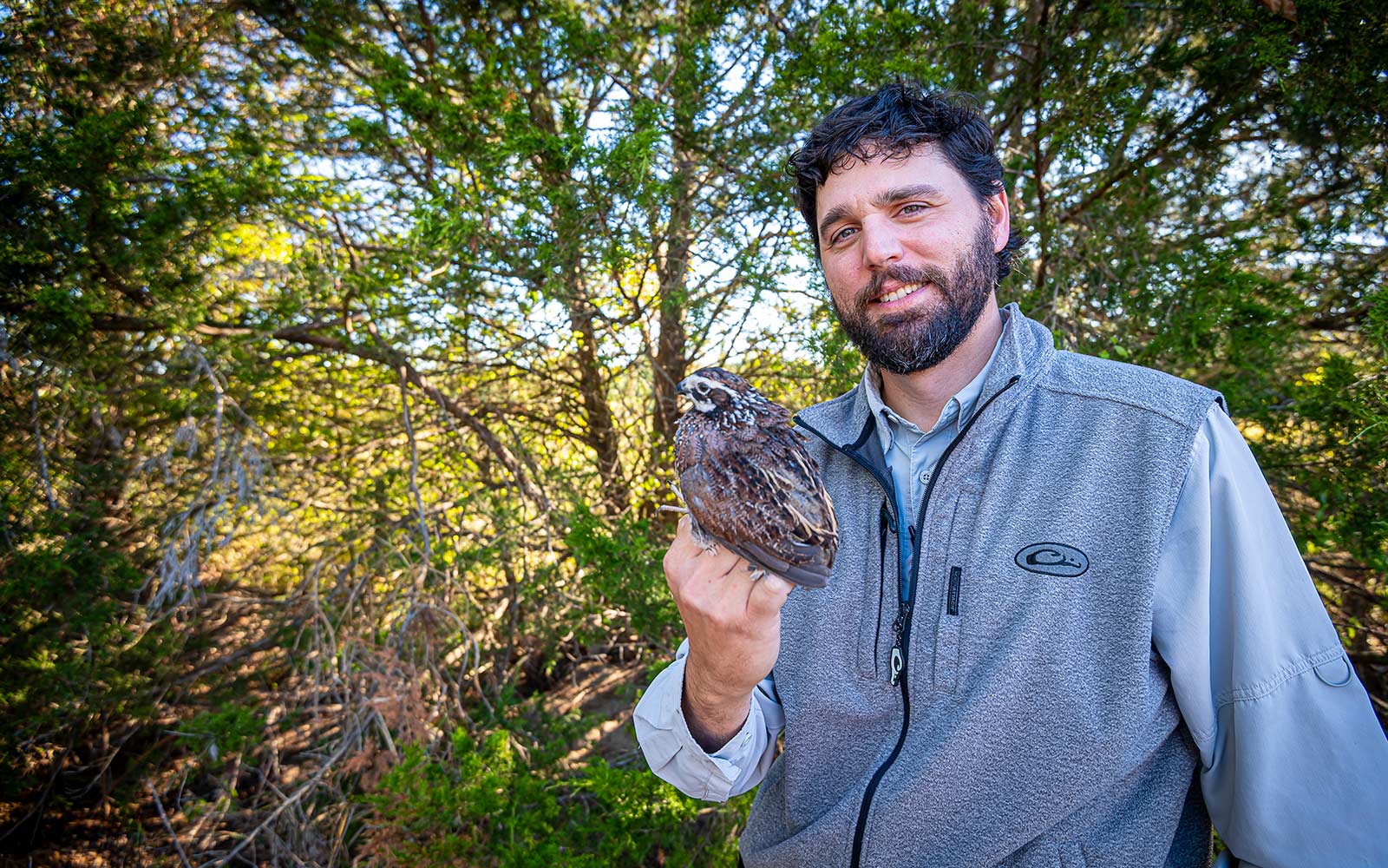 man in woods with bird