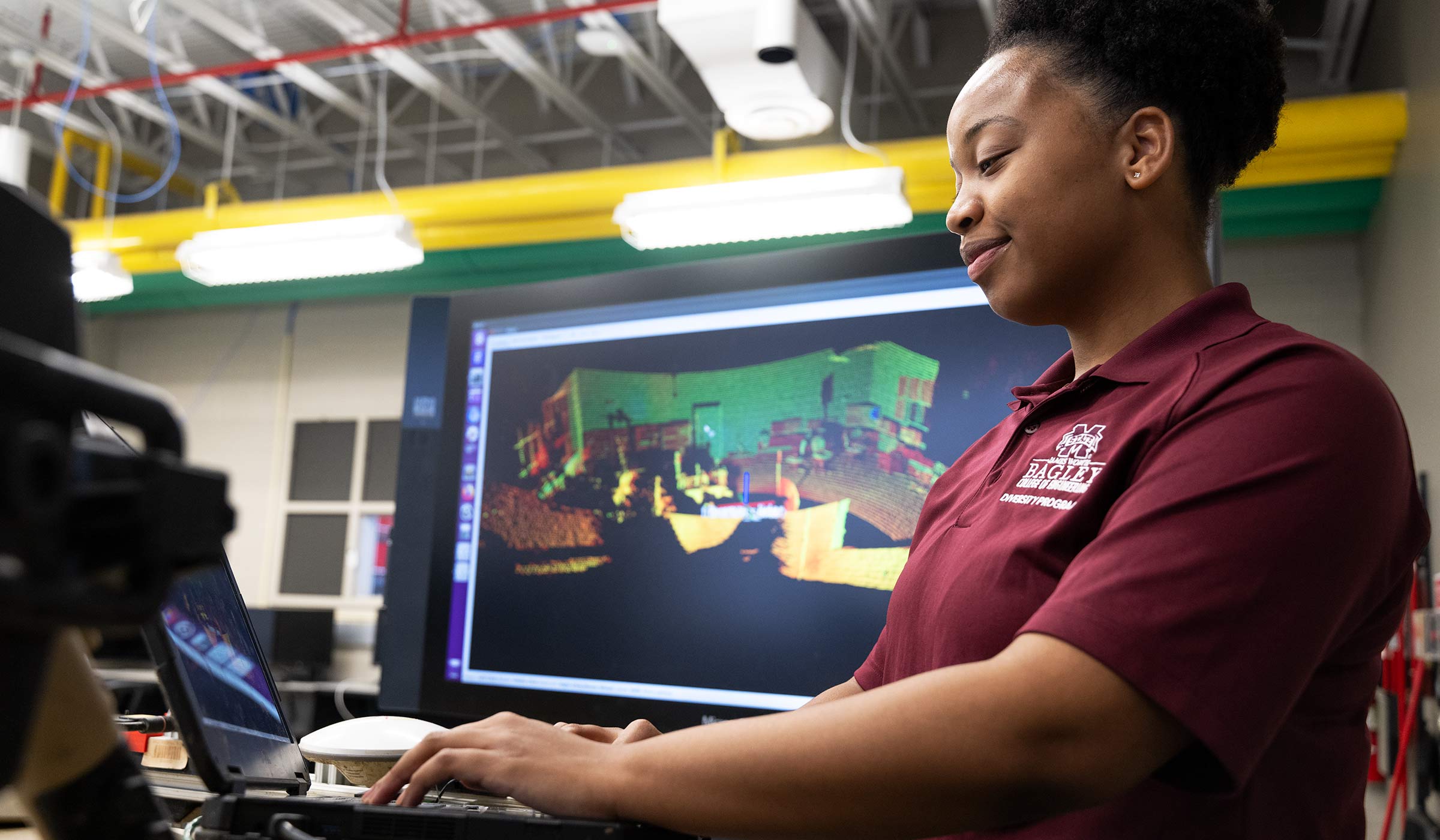 Kennedy Keyes, pictured in front of a screen with digital simulations