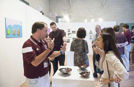 Former ACCESS student Wade Sims, left, discusses his artwork during a 2016 exhibit hosted by the ACCESS Program. (Photo by Megan Bean)