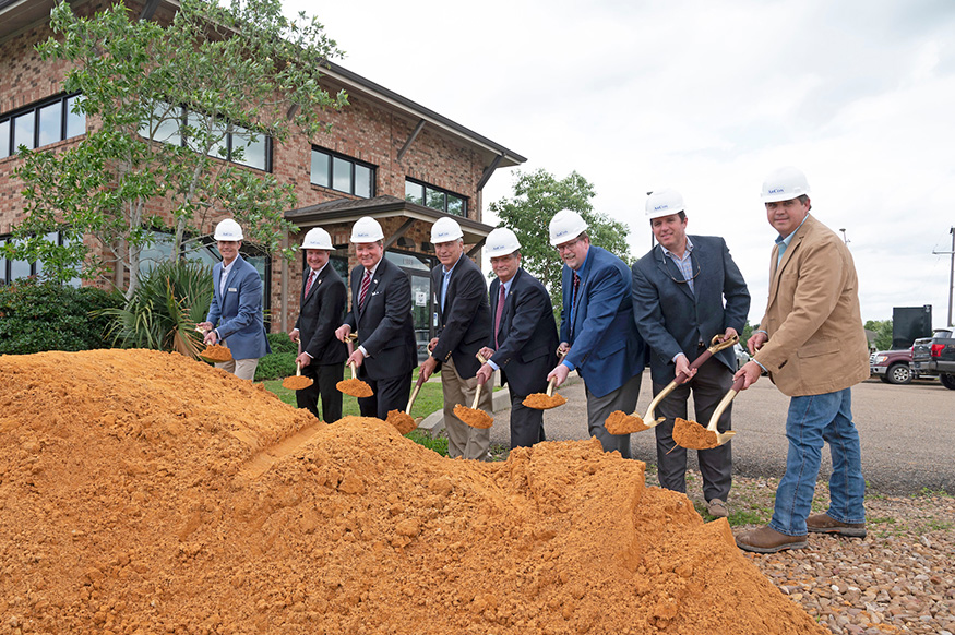 MSU, Machado Patano Design Group, and ARCON Group leaders hold shovels near a large pile of clay at the Animal Emergency & Referral Center's expansion groundbreaking ceremony.