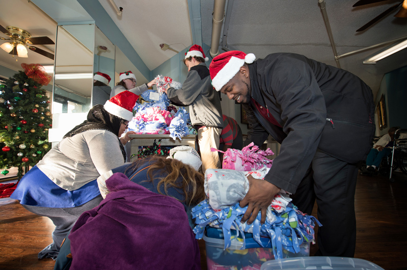 Mississippi State University Division of Student Affairs personnel distribute approximately 115 blankets and cards at Starkville Manor Nursing Home on Thursday [Dec. 15]. (Photo by Megan Bean)