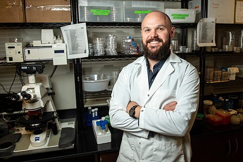 Matthew Brown poses in a laboratory.