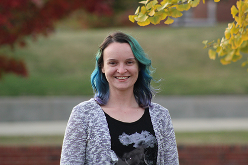 Claire Geneser pictured outside with trees and grass in the background